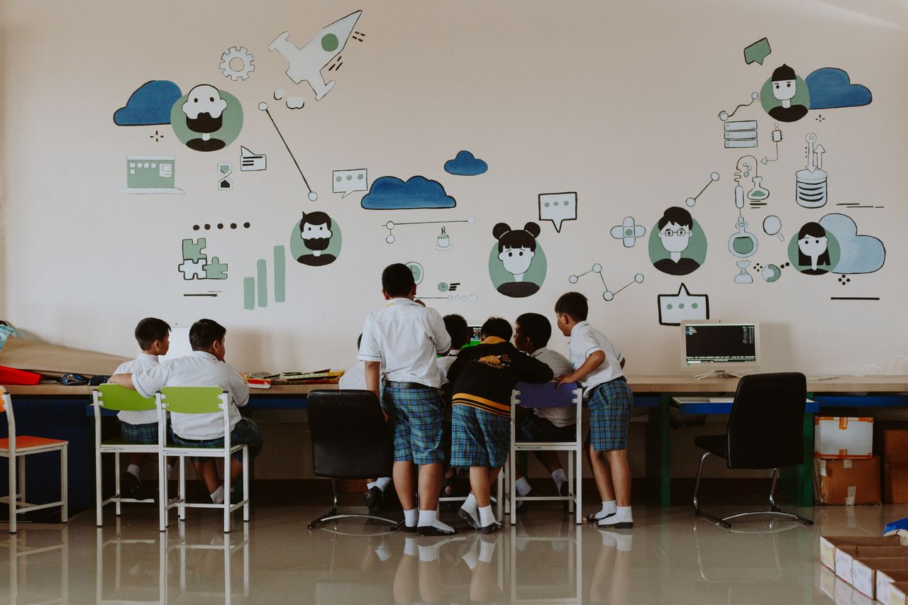 Students exploring technology in a colorful classroom environment, fostering education.